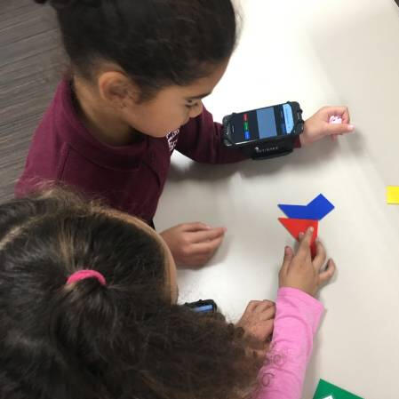 young girl students playing educational games