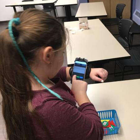 a young girl student using phone